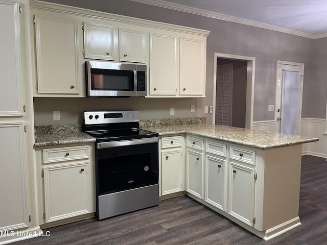 kitchen with kitchen peninsula, appliances with stainless steel finishes, white cabinetry, and light stone counters