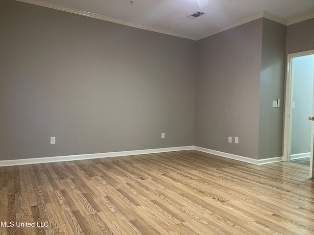 empty room with light wood-type flooring and ornamental molding