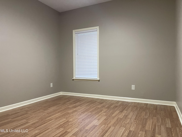 empty room with hardwood / wood-style floors