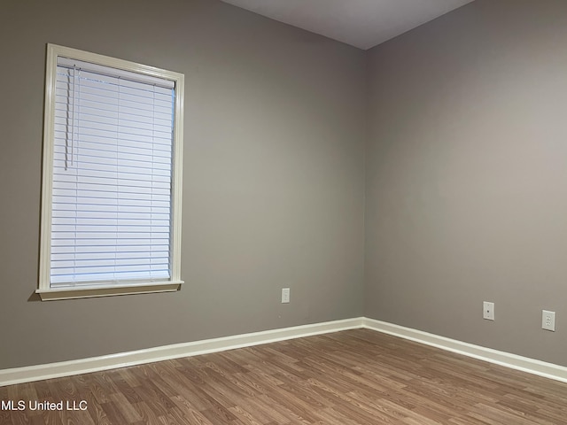 unfurnished room with hardwood / wood-style floors