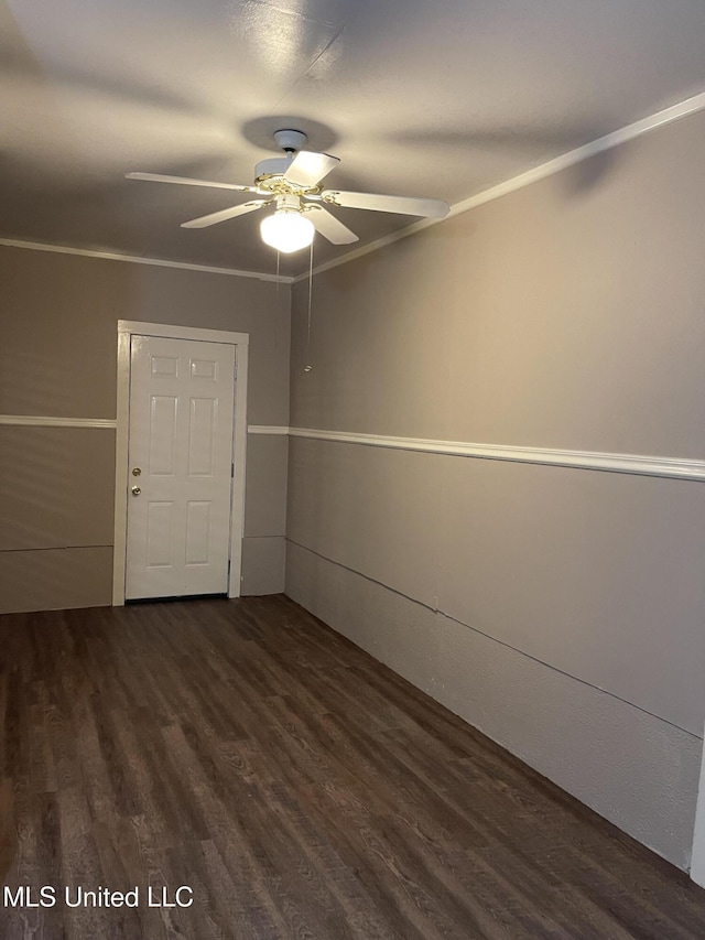 spare room with ceiling fan, dark hardwood / wood-style flooring, and crown molding