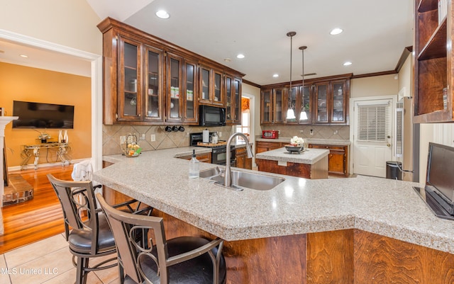 116 Hidden Hills Dr, Madison, MS 39110 - kitchen with black microwave, crown molding, recessed lighting, a peninsula, and light countertops