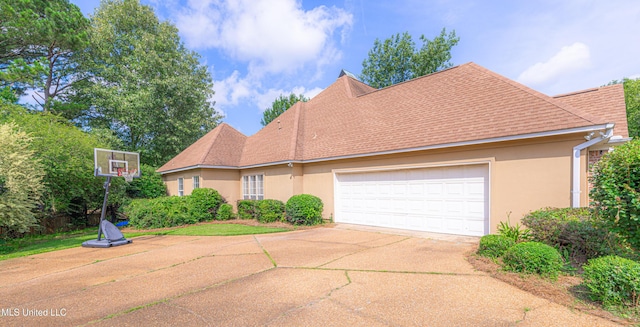 116 Hidden Hills Dr, Madison, MS 39110 - view of front of property featuring concrete driveway, stucco siding, an attached garage, and a shingled roof