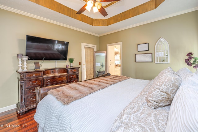 116 Hidden Hills Dr, Madison, MS 39110 - bedroom featuring dark wood-style floors, ornamental molding, a tray ceiling, a ceiling fan, and ensuite bath