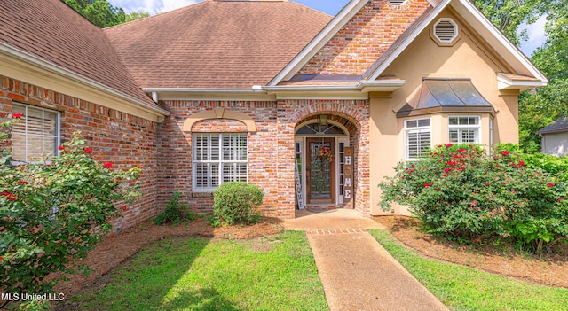 116 Hidden Hills Dr, Madison, MS 39110 - doorway to property with stucco siding, brick siding, and a shingled roof