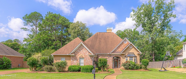 116 Hidden Hills Dr, Madison, MS 39110 - traditional-style home with brick siding, roof with shingles, stucco siding, and a chimney