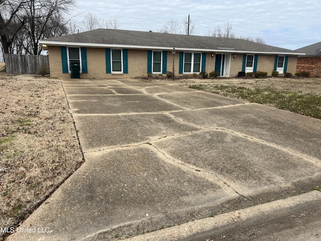 ranch-style house with brick siding and fence