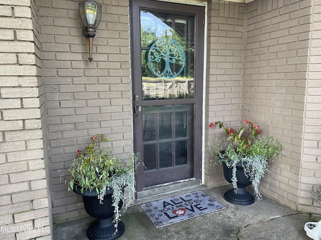 entrance to property with brick siding