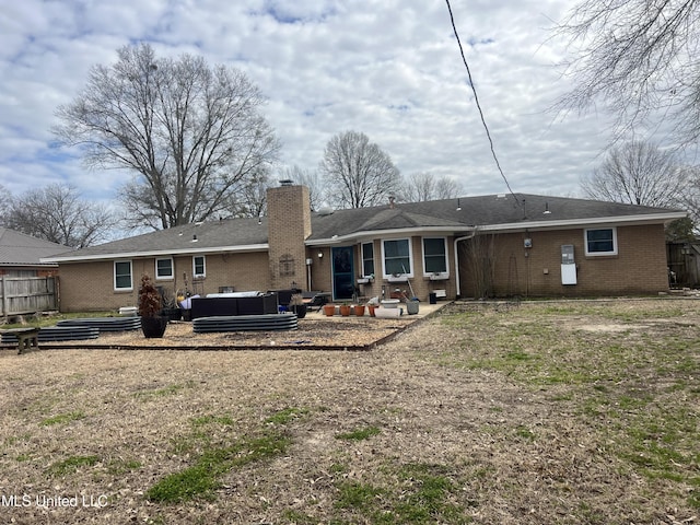 back of house with an outdoor hangout area, brick siding, a chimney, and fence