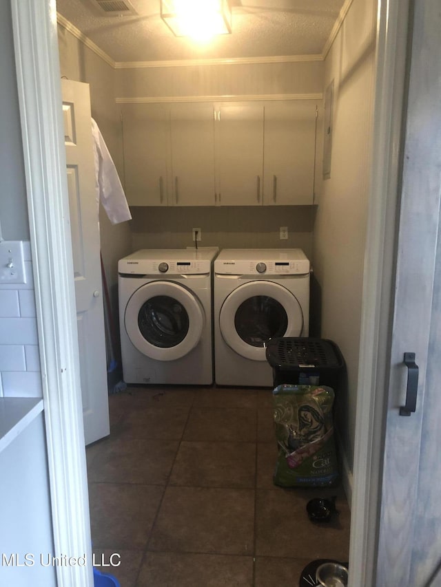 laundry room featuring washer and dryer, tile patterned flooring, and cabinet space