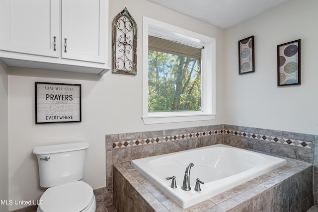 bathroom featuring toilet and tiled tub