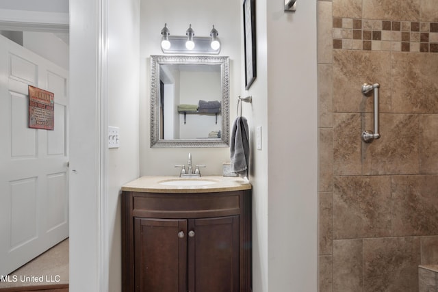 bathroom featuring vanity and tiled shower