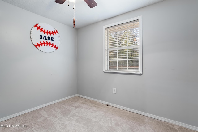 carpeted empty room with ceiling fan