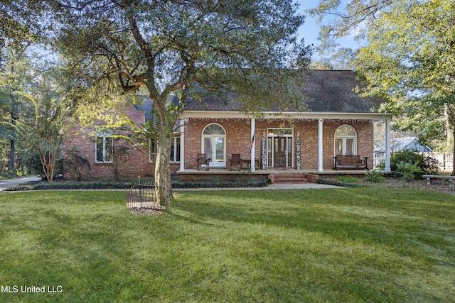 view of front facade with a front yard and covered porch