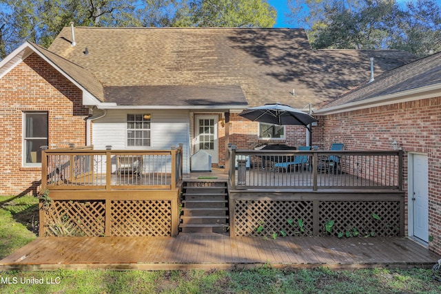 back of property with a deck