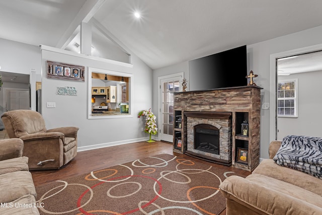 living room with a stone fireplace, dark wood-type flooring, and high vaulted ceiling