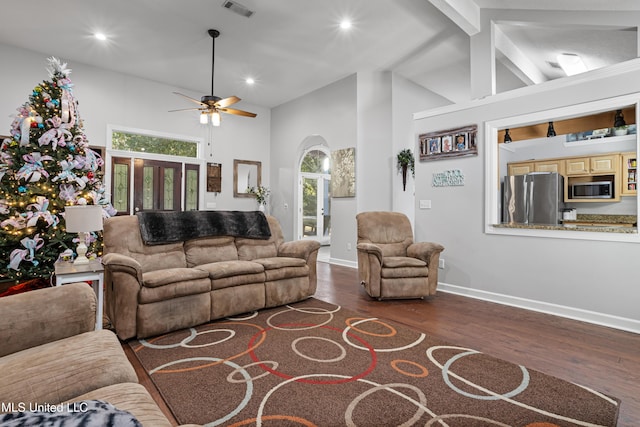 living room with beamed ceiling, dark hardwood / wood-style floors, ceiling fan, and high vaulted ceiling