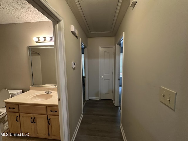1664 Thomas St, Horn Lake, MS 38637 - hall with attic access, a sink, dark wood finished floors, and baseboards