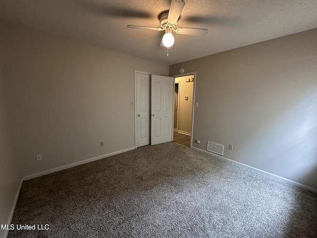1664 Thomas St, Horn Lake, MS 38637 - unfurnished bedroom featuring baseboards, carpet floors, a ceiling fan, and a textured ceiling