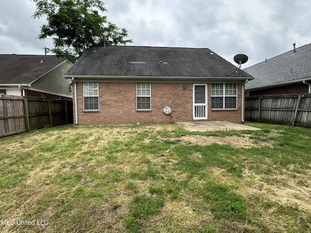1664 Thomas St, Horn Lake, MS 38637 - back of property featuring brick siding and a patio