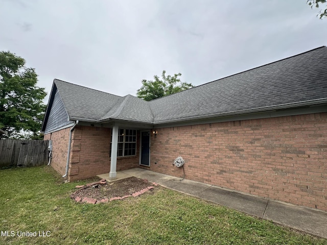 1664 Thomas St, Horn Lake, MS 38637 - rear view of property with roof with shingles and brick siding