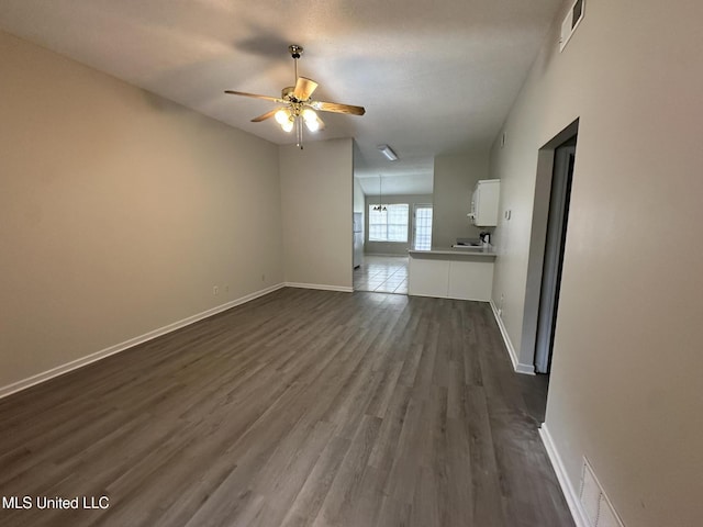 1664 Thomas St, Horn Lake, MS 38637 - unfurnished living room with dark wood-style flooring, ceiling fan, and baseboards