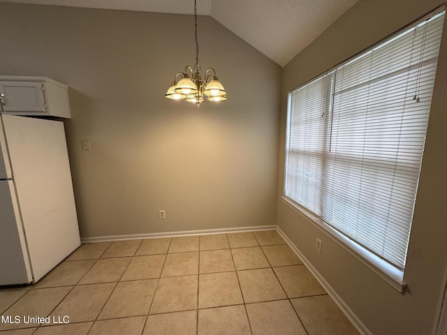 1664 Thomas St, Horn Lake, MS 38637 - unfurnished dining area with light tile patterned flooring, lofted ceiling, a chandelier, and baseboards