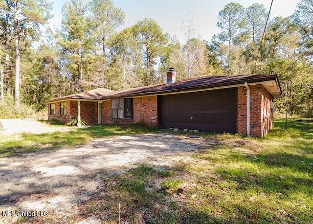 ranch-style home with a front yard and a garage