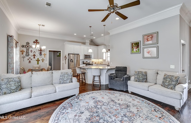 living room with ceiling fan with notable chandelier, visible vents, dark wood-style flooring, and ornamental molding