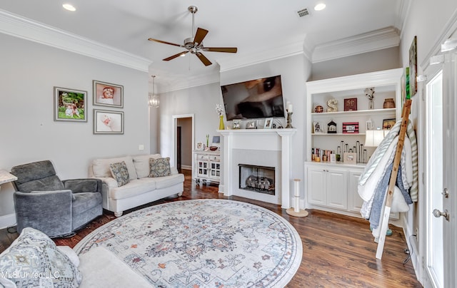 living room featuring ornamental molding, a fireplace, dark wood finished floors, and visible vents