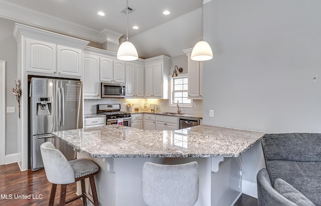 kitchen with tasteful backsplash, a kitchen breakfast bar, light stone countertops, stainless steel appliances, and a sink