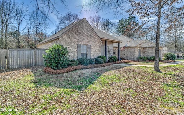 view of front of property with fence and brick siding