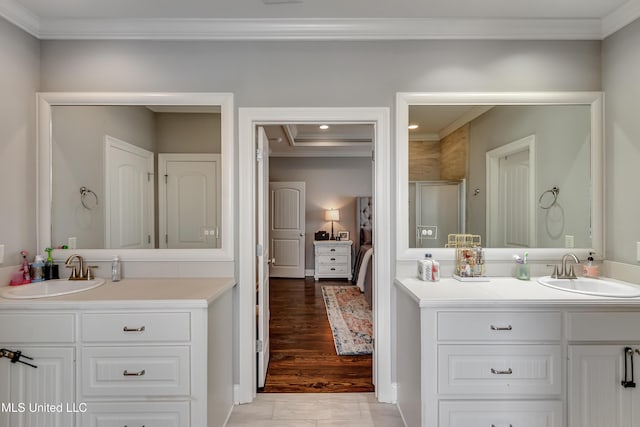 bathroom featuring two vanities, a sink, and crown molding