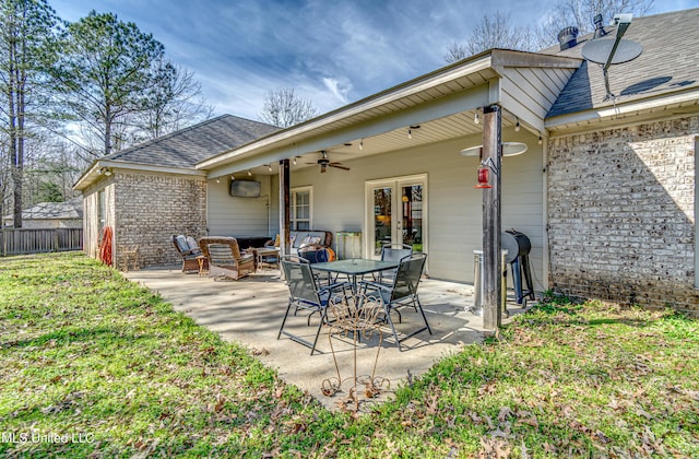 rear view of house featuring ceiling fan, fence, french doors, a patio area, and brick siding