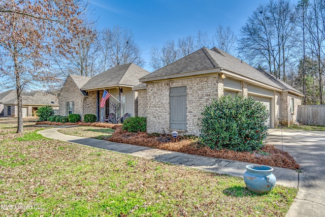 view of front of property with a garage, driveway, and brick siding