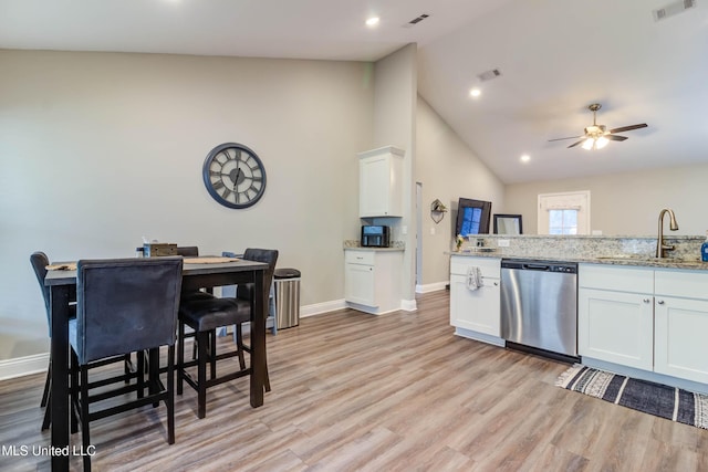 kitchen with a sink, light wood-style flooring, visible vents, and dishwasher