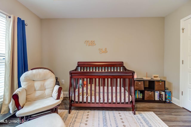 bedroom featuring baseboards and wood finished floors