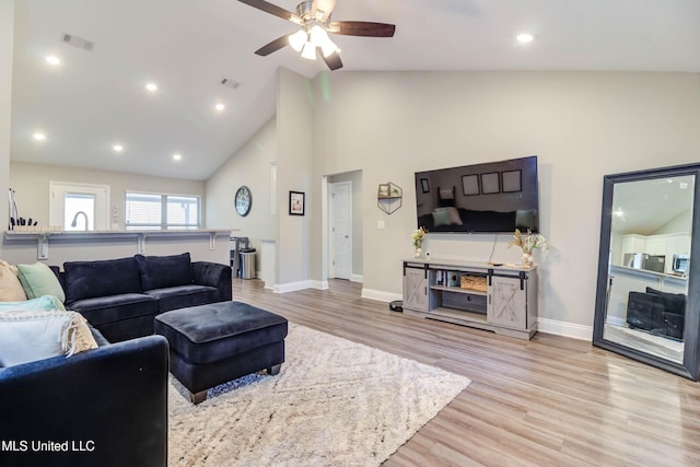 living room featuring light wood finished floors, recessed lighting, visible vents, and baseboards