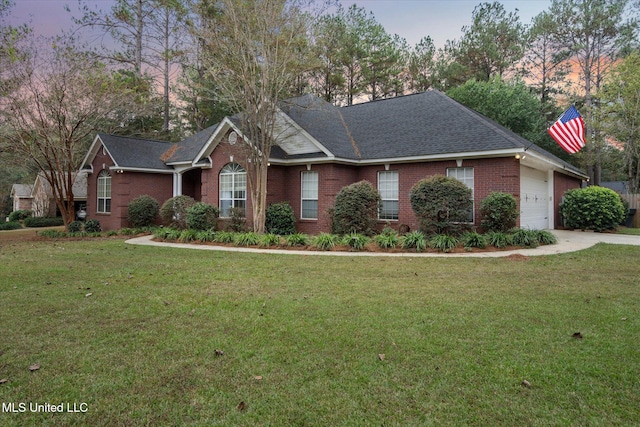 single story home with a lawn and a garage