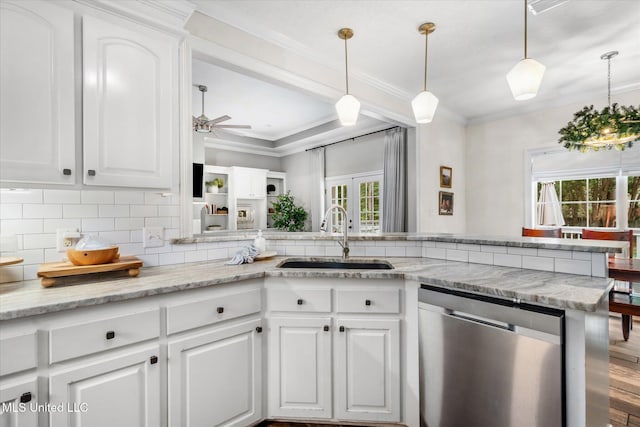 kitchen with stainless steel dishwasher, white cabinets, sink, and a wealth of natural light