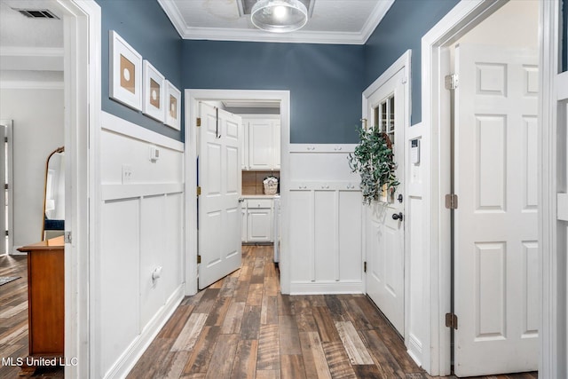 hallway with ornamental molding and dark wood-type flooring