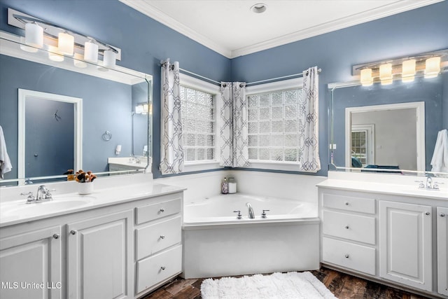 bathroom featuring hardwood / wood-style floors, a washtub, ornamental molding, and vanity