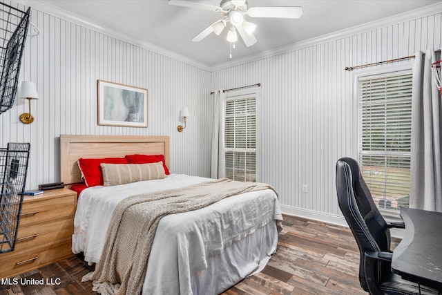 bedroom with dark hardwood / wood-style floors, ceiling fan, and ornamental molding