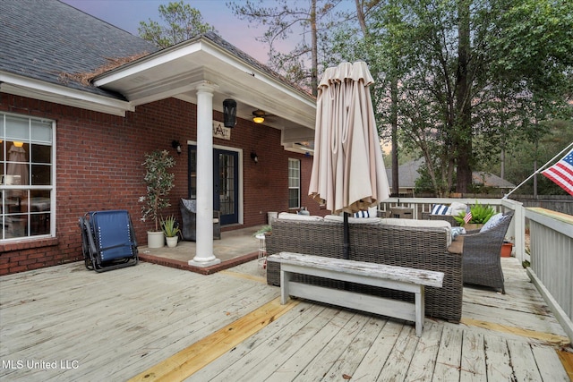 deck at dusk featuring an outdoor hangout area