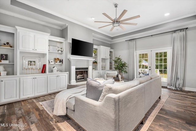 living room with ceiling fan, french doors, dark hardwood / wood-style floors, and ornamental molding