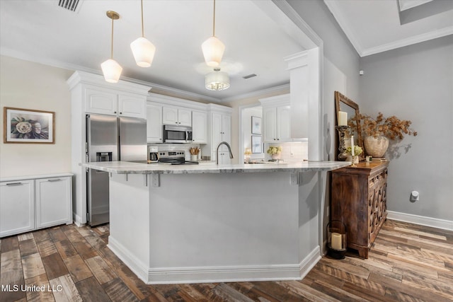 kitchen with decorative light fixtures, stainless steel appliances, white cabinetry, and dark wood-type flooring