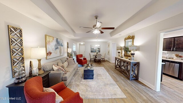 living room featuring ceiling fan and light hardwood / wood-style flooring