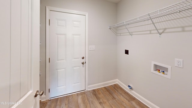 washroom featuring hookup for an electric dryer, washer hookup, and light hardwood / wood-style flooring