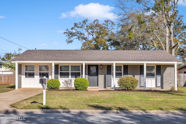 ranch-style house featuring brick siding, a porch, a front yard, and fence