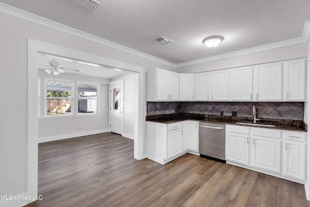 kitchen with visible vents, ornamental molding, a sink, stainless steel dishwasher, and backsplash